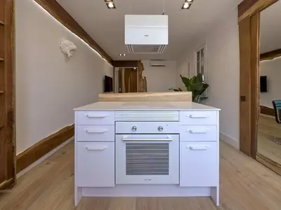 a kitchen with a white island in a room at Stay U-nique Apartment Padilla in Barcelona