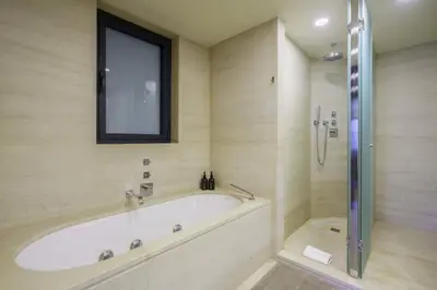 a bath tub in a bathroom with a window at Ola Living Paseo de Gracia in Barcelona