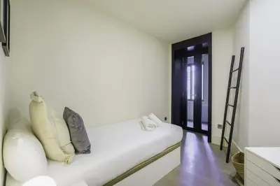 a white couch in a room with a black door at Ola Living Paseo de Gracia in Barcelona