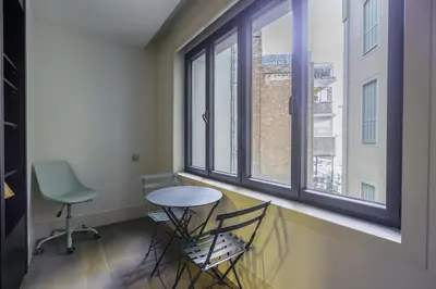 a room with a table and two chairs and a window at Ola Living Paseo de Gracia in Barcelona