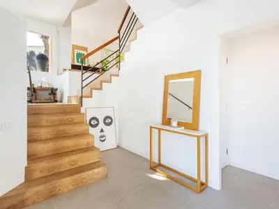 a room with a staircase with a mirror and a mirror at Villa Alella Panoramic Views in Alella