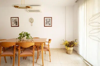 a dining room with a wooden table and chairs at Apartamento Luxury Gran Via 2 in Hospitalet de Llobregat