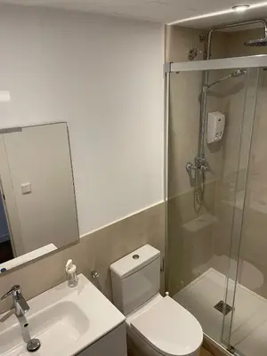 a bathroom with a toilet and a shower and a sink at Gaudi Street Apartments in Sitges