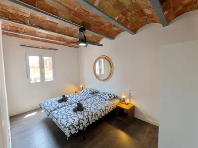 a bedroom with a bed and a mirror on the wall at Magnificent apartment Camp Nou in Hospitalet de Llobregat