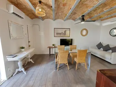 a living room with a table and chairs and a couch at Magnificent apartment Camp Nou in Hospitalet de Llobregat