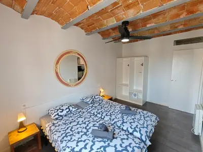 a bedroom with a bed and a mirror at Magnificent apartment Camp Nou in Hospitalet de Llobregat