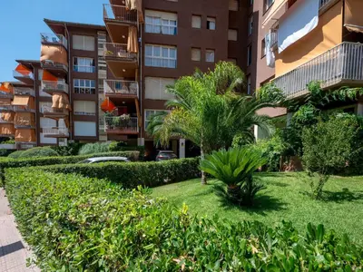 a garden in front of a apartment building at Apartment Els Pins by Interhome in Sant Vicenç de Montalt
