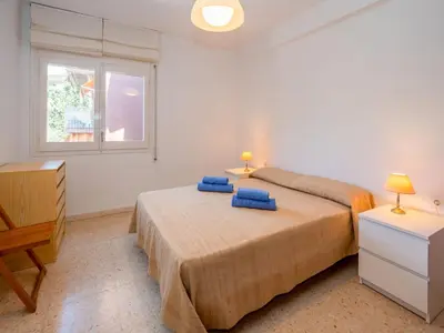 a bedroom with two beds and a window at Apartment Els Pins by Interhome in Sant Vicenç de Montalt