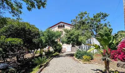 a house with a garden in front of it at Historic house 5 minutes walk from the beach in San Pol de Mar