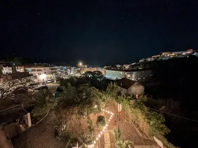 a view of a city at night with lights at Historic house 5 minutes walk from the beach in San Pol de Mar