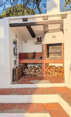 a building with a pile of fire wood at Historic house 5 minutes walk from the beach in San Pol de Mar