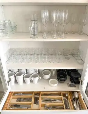 a cupboard filled with glasses and plates and dishes at Apartment Coloma Piscina y Parking Hostem in Vilanova i la Geltrú