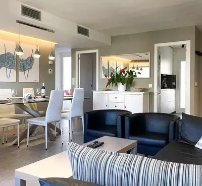 a living room with a dining room and a kitchen at Apartment Coloma Piscina y Parking Hostem in Vilanova i la Geltrú
