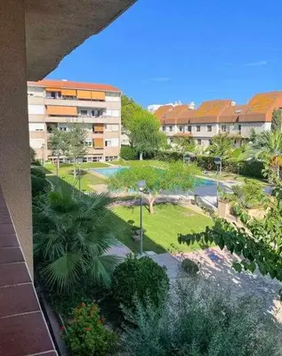 a view of a park with palm trees and buildings at Apartment Coloma Piscina y Parking Hostem in Vilanova i la Geltrú