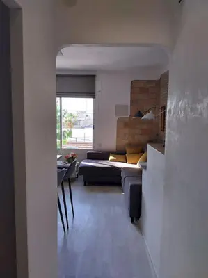 a living room with a couch and a table at La Bellamar - Apartamento en primera línea mar- in Premiá de Mar