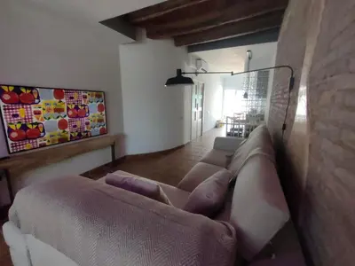 a living room with a couch and a painting on the wall at La Bellamar - Apartamento en primera línea mar- in Premiá de Mar
