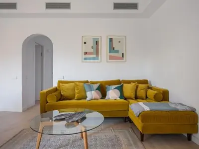 a living room with a yellow couch and a glass table at Sunny Apartment 3bed with terraze in Barcelona