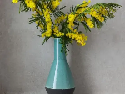 a blue vase filled with yellow flowers on a table at Sunny Apartment 3bed with terraze in Barcelona