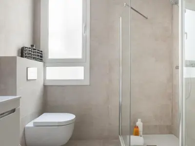 a bathroom with a toilet and a glass shower at Sunny Apartment 3bed with terraze in Barcelona