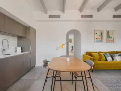 a living room with a table and a yellow couch at Sunny Apartment 3bed with terraze in Barcelona