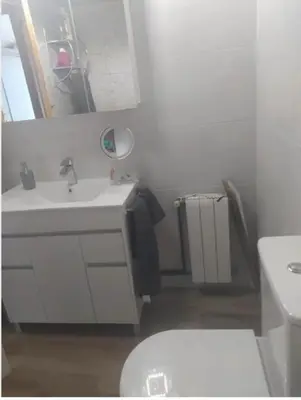 a bathroom with a white sink and a toilet at Primera línea de mar y piscina a 20 minutos de Barcelona in Premiá de Mar