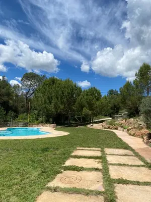 a yard with a swimming pool and a cloudy sky at Cal Masses , St. Salvador de Guardiola in Guardiola