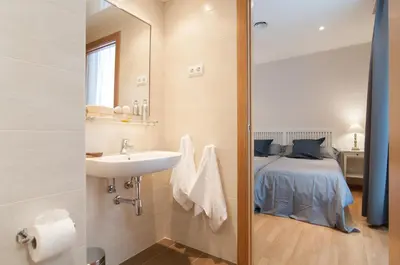 a bathroom with a sink and a bed at Pelayo Deluxe Apartments in Barcelona