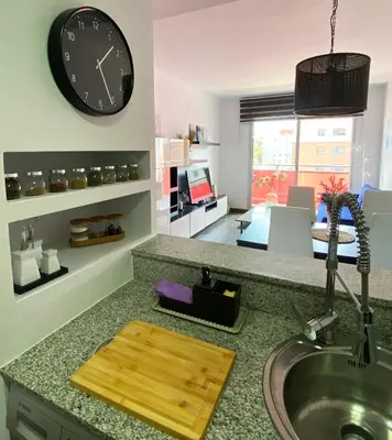 a kitchen with a sink and a clock on the wall at Barcelona Beach Breeze in Barcelona