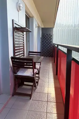 a balcony with a bench and a table and chairs at Barcelona Beach Breeze in Barcelona