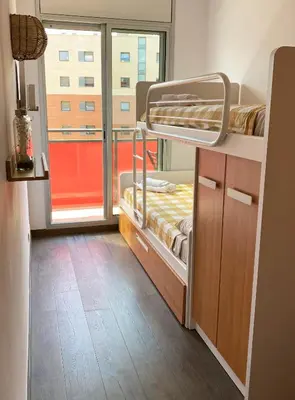 a room with two bunk beds and a window at Barcelona Beach Breeze in Barcelona