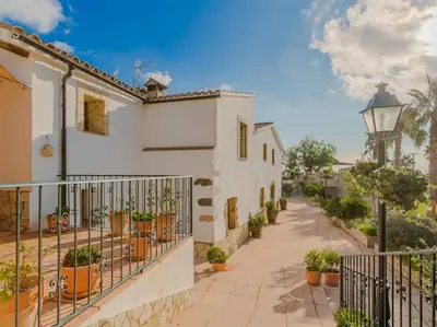 a house with a balcony and a street with plants at Finca Montnegre Suites and Spa in Sant Iscle de Vallalta