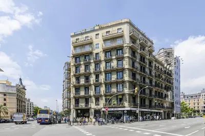 a tall building on the corner of a city street at Canela Homes BARCELONA BALMES in Barcelona