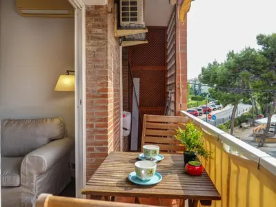 a table on a balcony with two cups of coffee at The Beach Apartment by Hello Homes Sitges in Sitges