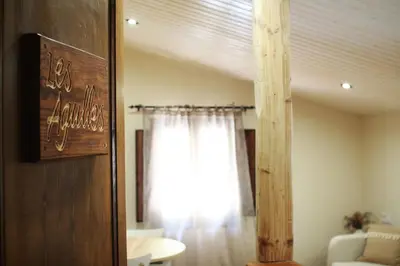a living room with a window and a curtain at El Celler de la Guàrdia in Montserrat