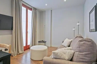 a living room with a couch and a table at Uma Suites Barceloneta Beach in Barcelona
