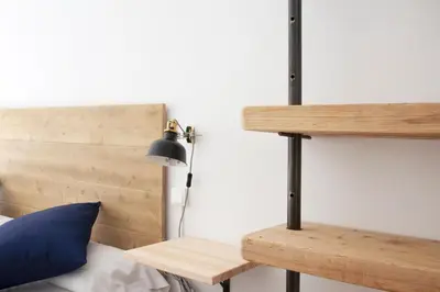 a bedroom with a bed with a desk and a lamp at My Address in Sant Antoni in Barcelona