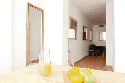a table with a glass of orange juice and some lemons at My Address in Sant Antoni in Barcelona