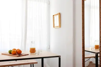 a table with oranges and a glass of orange juice at My Address in Sant Antoni in Barcelona