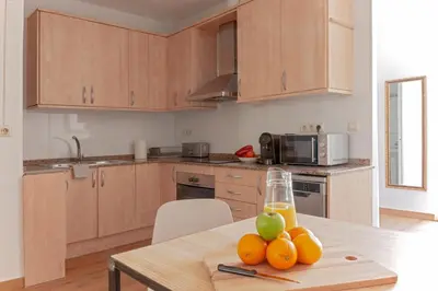 a kitchen with a table with fruit on it at My Address in Sant Antoni in Barcelona