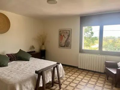a bedroom with a bed and a window at Cal Muntanyès in Font-Rubí