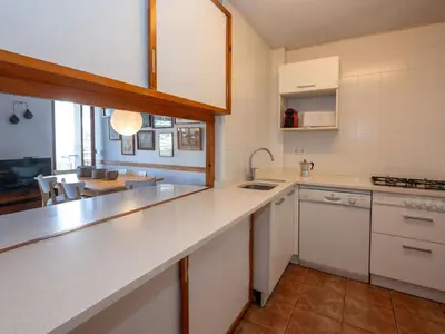 a kitchen with white appliances and a dining room at Apartment Zodiak by Interhome in Pineda de Mar