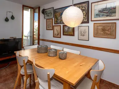 a dining room with a wooden table and chairs at Apartment Zodiak by Interhome in Pineda de Mar