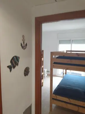 a bedroom with a bunk bed next to a door at CAN TRULLEN CHALET CALAFELL in Calafell