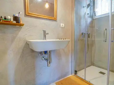 a bathroom with a sink and a shower at Simba Apartment by Hello Homes Sitges in Sitges