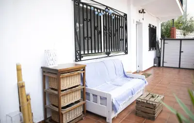 a porch with a bench and a iron gate at Simba Apartment by Hello Homes Sitges in Sitges