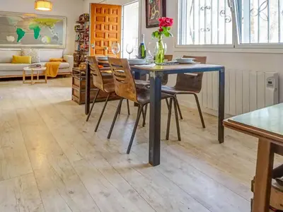 a dining room with a blue table and chairs at Simba Apartment by Hello Homes Sitges in Sitges