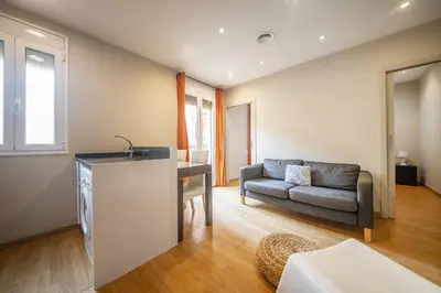 a living room with a couch and a table at Catalunya Casas 2 bed apartment in Barceloneta steps from the beach in Barcelona