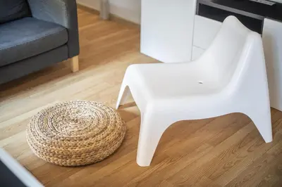 a white chair and a table and a stool at Catalunya Casas 2 bed apartment in Barceloneta steps from the beach in Barcelona