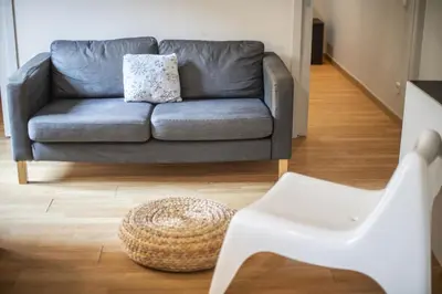a living room with a couch and a chair at Catalunya Casas 2 bed apartment in Barceloneta steps from the beach in Barcelona