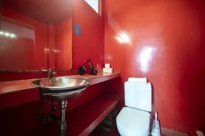 a red bathroom with a sink and a toilet at Catalunya Casas Pied-à-terre in central Barcelona 100m from beach in Barcelona